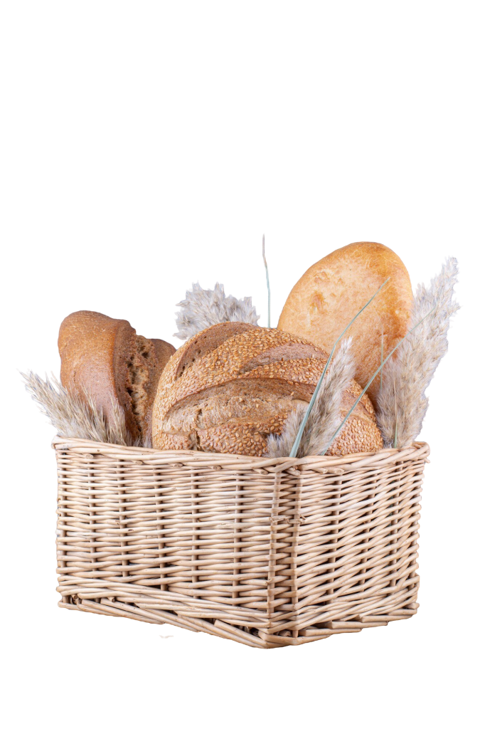cesta-cheia-de-paes-e-talos-de-grama-em-uma-superficie-de-marmore